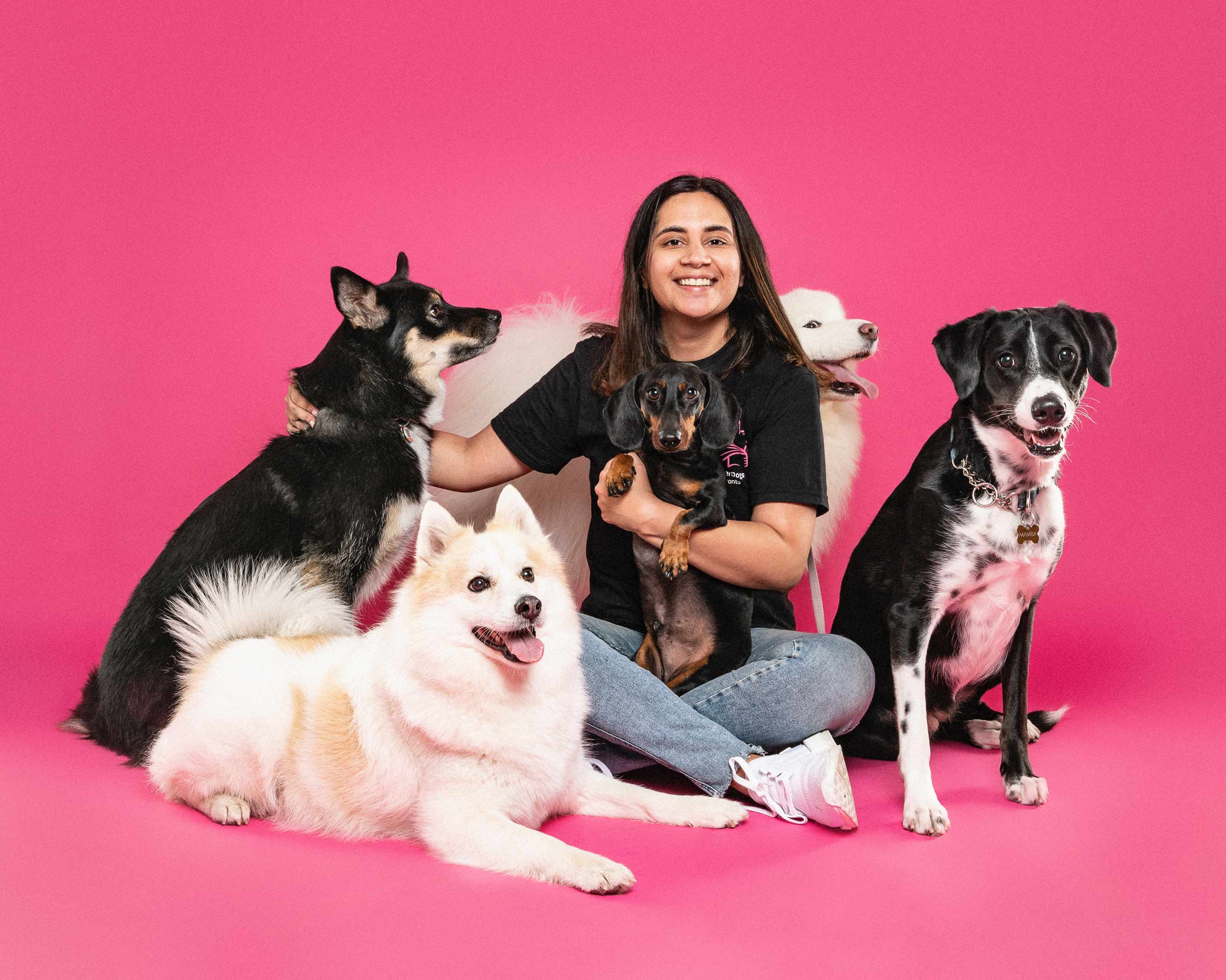Kritika, founder of SuperDoggos, sitting with dogs